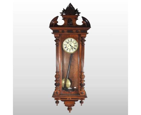 A 19th century walnut cased Vienna style regulator wall clock, with an enamel dial, 140cm high