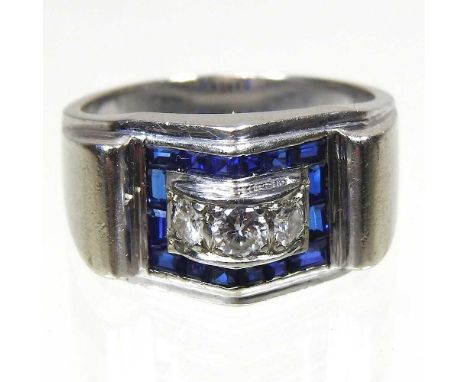 An Art Deco style 14 carat white gold, diamond and sapphire ring, set with three central diamonds, within a sapphire surround