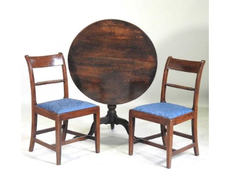 A George III oak occasional table, with a hinged circular top, on a tripod base, 81cm diameter, together with a pair of Regen
