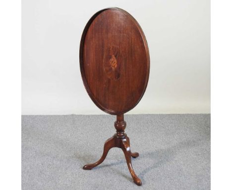 A 19th century oval inlaid occasional table, with a hinged top, on a tripod base66w x 48d x 74h cm