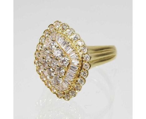 An 18 carat gold diamond cluster ring, set with thirty three diamonds and thirty two baguette diamonds, approximately 2.0 car