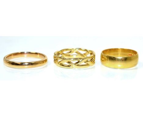 A broad 22 carat gold band ring, finger size M; a 22 carat rose gold band ring, finger size R and 18 carat gold entwined band