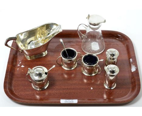 A silver sauce boat and ladle; a silver mounted whisky noggin and a five piece condiment set 