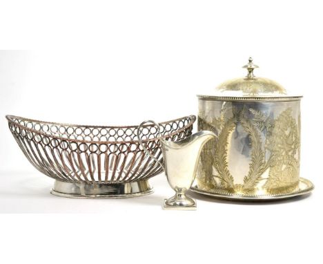 A silver helmet shaped cream jug; a Victorian plated biscuit box; and a Sheffield plate bread basket 