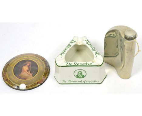 An advertising ashtray together with an advertising paperweight and a white metal hip flask (3)