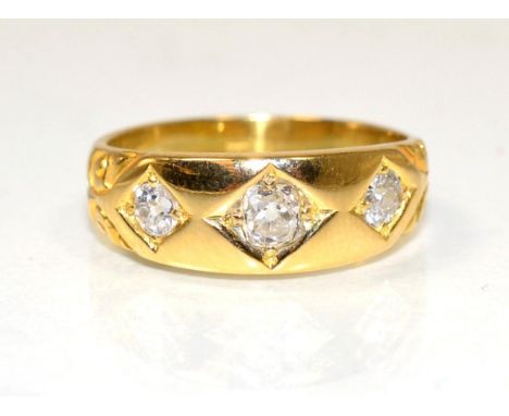 A three stone diamond ring, star set graduated old cut diamonds, to a tapering shank, total estimated diamond weight 0.40 car