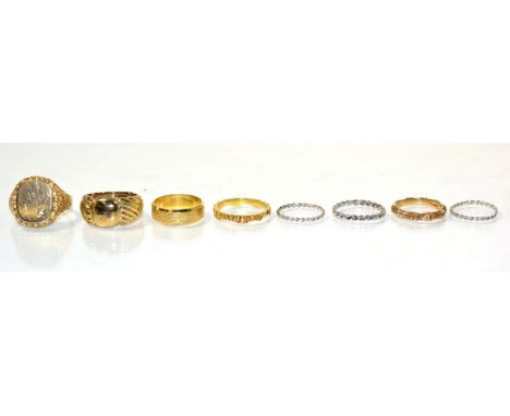An 18 carat gold textured band ring, finger size M; a 9 carat gold diamond signet ring, an oval top star set with a single ro