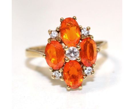 A 9 carat gold fire opal and diamond cluster ring, a central round brilliant cut diamond within four oval cut fire opals and 