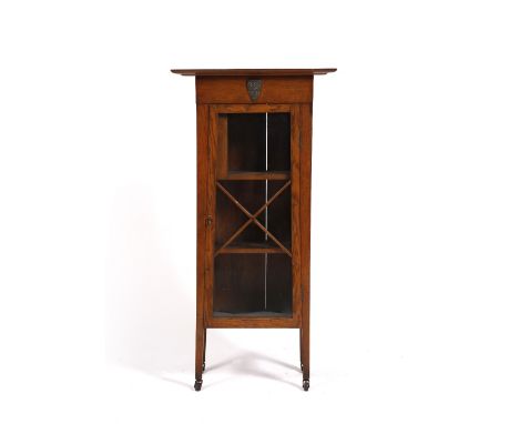 Arts & Crafts Oak bookcase, circa 1920 decorated with coat of arms of Cambridge University the glazed door enclosing shelves 