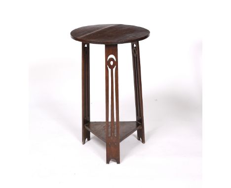 Liberty & Co. Oak occasional table, circa 1900 circular top over three pierced legs united by under shelf 68cm high, 42cm wid