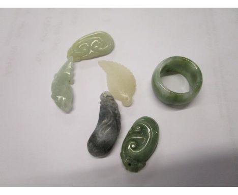 A group of five Chinese jade carved pendants and a green jade ring, early 21st century 