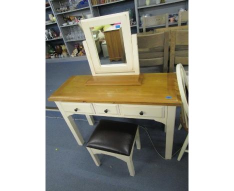 A cream painted and light wood dressing table with matching stool having black faux leather top and a cream painted and light