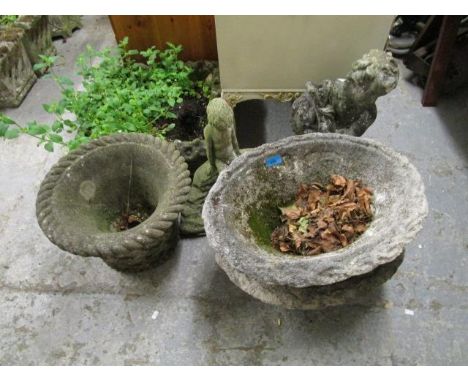 A pair of weathered concrete garden planters of oval form, trellis and flower head decoration, along with a concrete square l