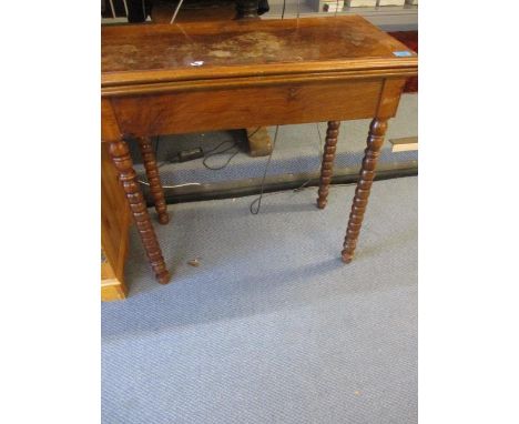 A 19th century walnut card table with a rotating, fold over top on bobbin turned legs 