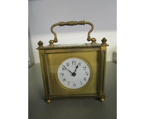 A square cased gilt brass, five window carriage clock with Arabic white enamel dial with makers/retailers name worn 