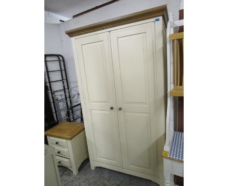 A cream painted and light wood double wardrobe with matching bedside chest of three drawers 