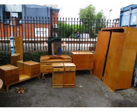 A six-piece G-Plan light oak dressing suite comprising pot cupboards, chest, dressing table and wardrobe 