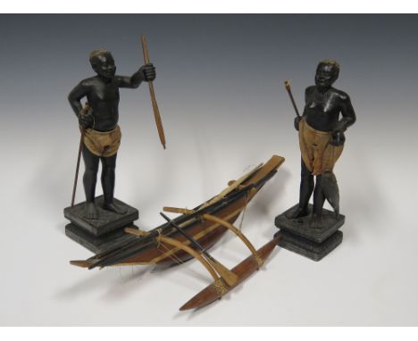 A Pair of East African Carved Wooden Figures of a Male and Female 32cm high and a model of canoe with outrigger
