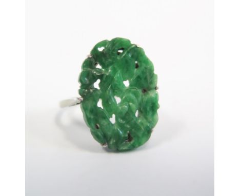 A Chinese Spinach Green Jade Ring in 18ct white gold and platinum mount with carved and pierced decoration