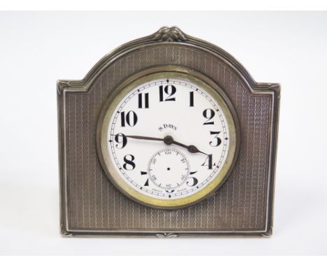 A George V Silver Cased Easel Back Desk Clock with engine turned decoration, enamelled dial and subsidiary seconds dial (hand