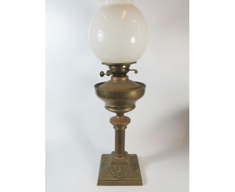 A Brass Oil Lamp with opaque glass shade