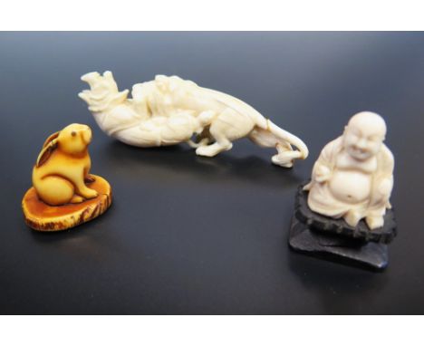 A Japanese Late Edo or Meiji Period Carved Ivory Netsuke in the form of a hare, carved ivory group of rhino and tiger and car