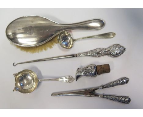 A Silver Tea Strainer, silver glove stretchers and button hook etc