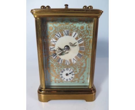 A French Brass Repeating Carriage Clock with enamelled dial and porcelain panels decorated with water birds, 16.5cm