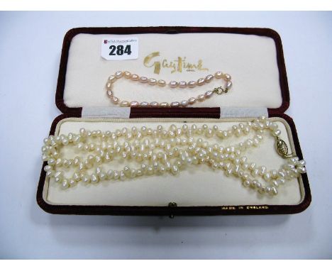 A Modern Fresh Water Pearl Bead Necklace, of two row design, to clasp stamped "375"; together with a bracelet, the clasp stam