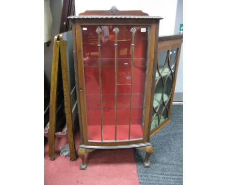 A 1920's Mahogany Slender Bow Front Display Cabinet, with shell motifs to low back and glazed door (cracked).