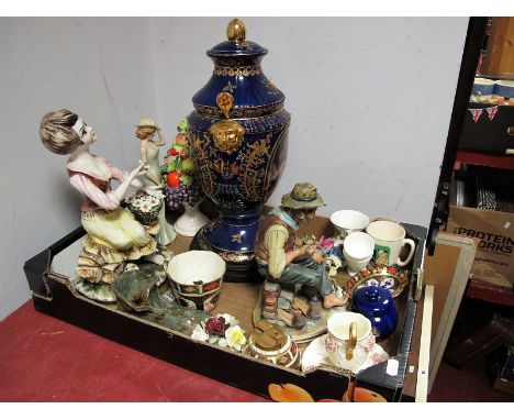 A Reproduction Pottery Urn and Cover, twin handled, gilt highlights with printed reserves of cherubs, on wooden plinth, Royal