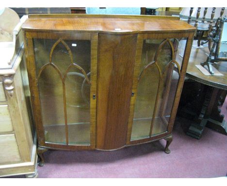 A Mid XX Century Walnut China Cabinet, with bow front centre panel, raised on squat cabriole legs.