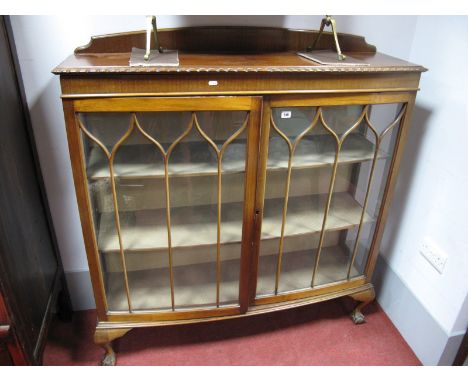 A 1920's Mahogany Bow Front Display Cabinet, with low back, gadrooned border, on ball and claw feet.