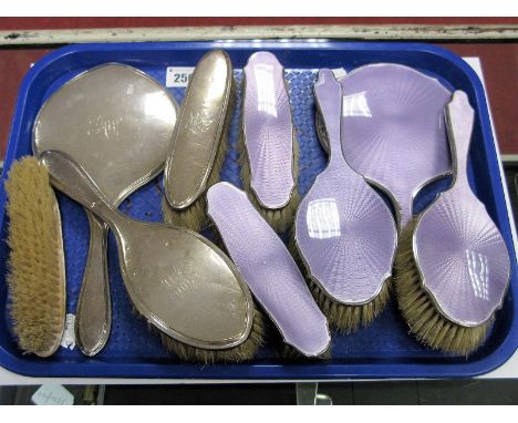 A Four Piece Hallmarked Silver Backed Dressing Table Set, plus a five piece silver mounted mauve enamel dressing table set. 