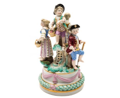 A Meissen figural group of children: after the model by J.J.Kandler, the four children wearing 18th century dress and carryin