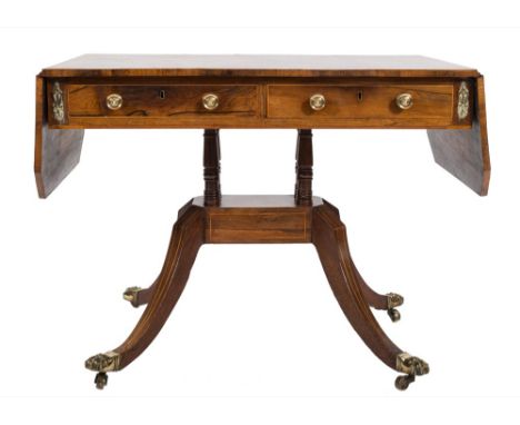 A Regency rosewood and inlaid sofa table:, bordered with boxwood and ebonised lines, the hinged top with cut corners and a sa