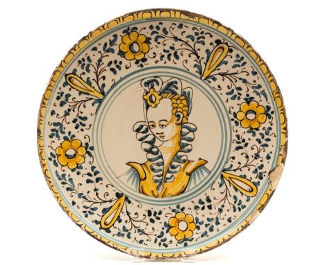 An Italian maiolica crespina: painted in blue, manganese and ocre with a head and shoulders portrait of a lady within a wide 