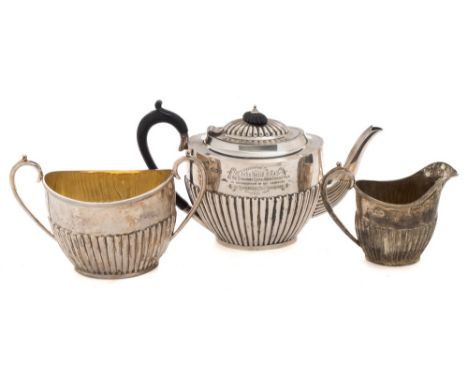 A Victorian silver three-piece tea service, maker John Round & Sons, Sheffield 1895/96:,inscribed, of oval outline with half-