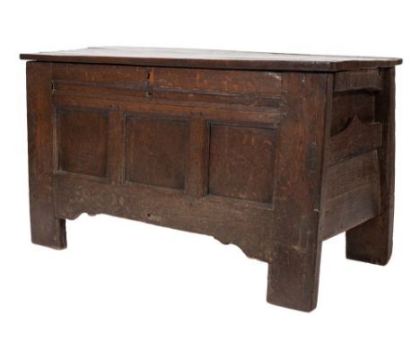 An 18th Century oak rectangular coffer:, with a plain hinged top and triple moulded panel front, having side pockets on exten
