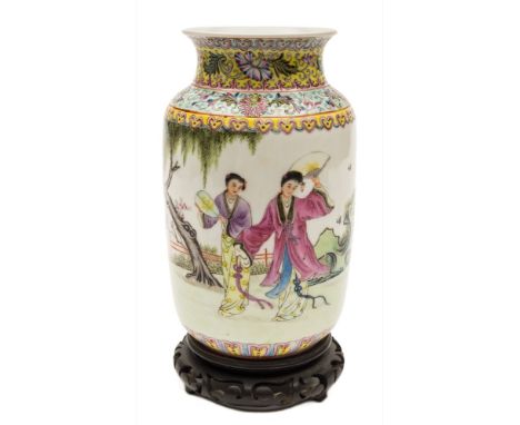 A Chinese porcelain vase: decorated in the famille rose palette with two female figures holding fans within a garden setting,