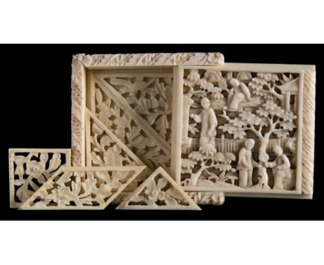 A 19th century Chinese carved ivory tangram puzzle: of square outline with sliding cover carved with figures in a pagoda land