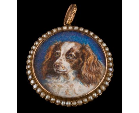 An early 20th century gold and seed-pearl circular miniature portrait locket: with central glazed panel 30mm diameter and hin