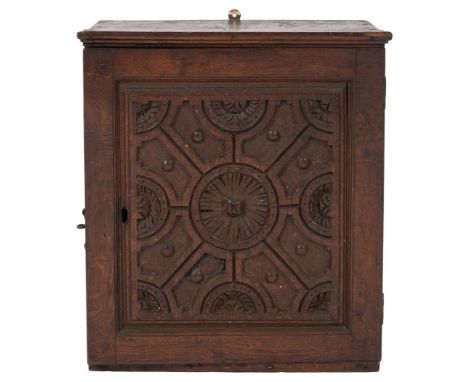 A late 17th/early 18th Century oak wall cabinet:, with a moulded cornice, having interior pigeon holes and two small drawers,