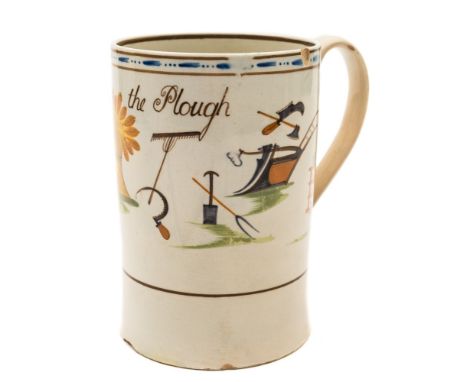 A Pratt creamware cylindrical mug: inscribed 'God speed the Plough' and painted with a large sheaf of corn and various farmer