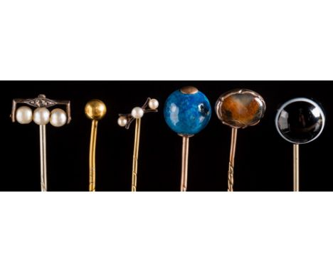 A collection of sixty-seven stick pins: with various gem-set motifs including a gold nugget, a patriotic ruby, diamond and sa