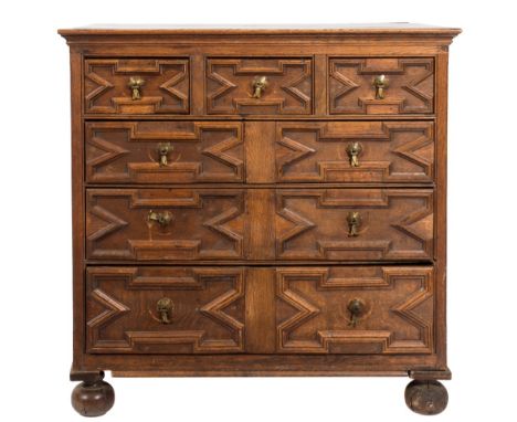 A 17th Century oak rectangular chest:, the top with a moulded edge, containing three short and three long geometrically mould
