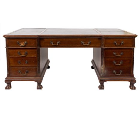 An Edwardian Indo-Colonial teak pedestal desk of large size:,  and broken outline with carved foliate and blind fret geometri