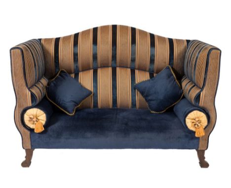 A contemporary sofa by Dudgeon of London:, upholstered in Royal blue and gold striped jab fabric, having a serpentine back, s