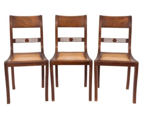 A set of eight Regency Colonial rosewood dining chairs:, the backs with broad curved bar top rails and pierced horizontal spl