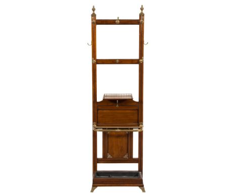 By Jas ShoolbredA late Victorian mahogany and brass mounted hall stand:, with reeded urn and bell topped finials, fitted with